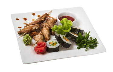 Buffalo chicken wings on plate with sushi