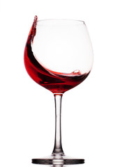 moving red wine glass over a white background