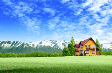 House and moutain on green field landscape with blue sky