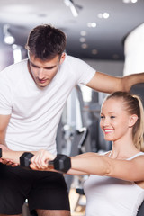 Woman exercising with personal trainer