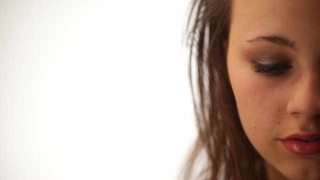 Half face of sad beautiful young woman isolated