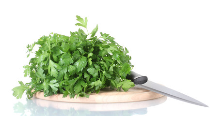 Parsley on a cutting board with knife isolated on white