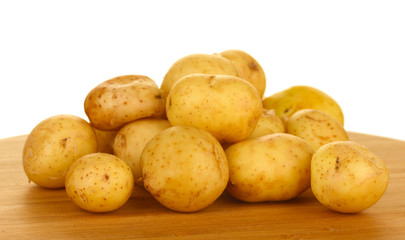 young potatoes on a cutting board on white background close-up