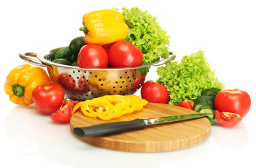 fresh vegetables and knife on cutting board isolated on white