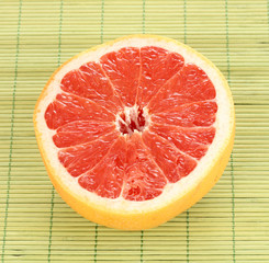 Ripe grapefruit on napkin isolated on white