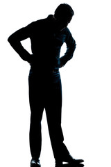 silhouette man full length looking at his shoes