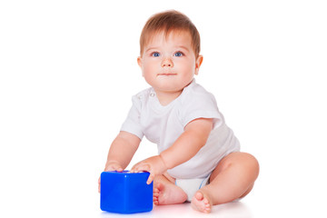 Little boy with a blue toy blocks, isolated on white