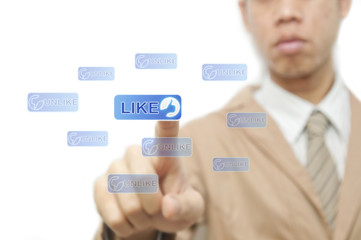 Fototapeta na wymiar Businessman finger pressing Social Network icon on like button