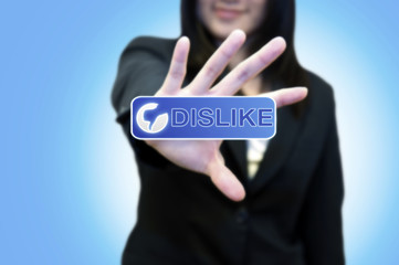 Business woman with hand touching DISLIKE button on touch screen