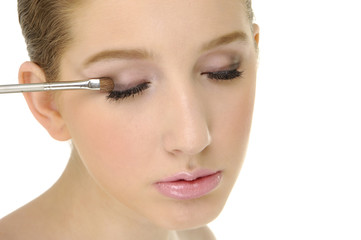 Young woman applying eye shadow