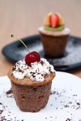 Muffin with cream and cherries