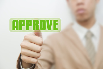 Business man pressing touch screen on approve button