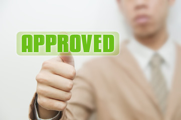 Business man pressing touch screen on approve button