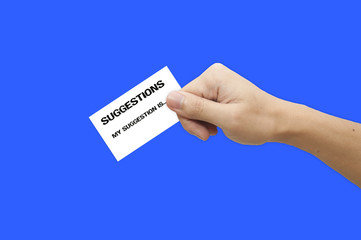 Hand holding suggestion paper over a blue background