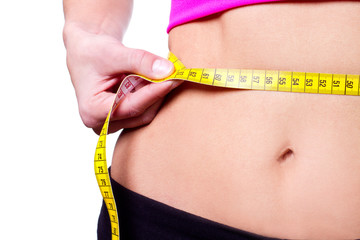slim girl measuring her waist - closeup, isolated