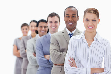Close-up of smiling people dressed in suits crossing their arms