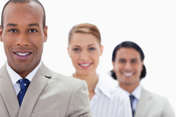 Big close-up of workmates in a single line smiling