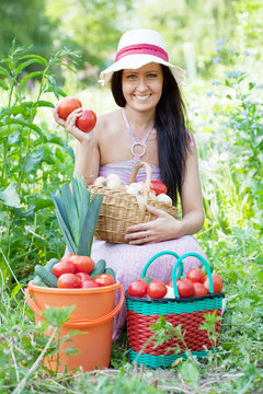 Happy woman with harvested vegetables