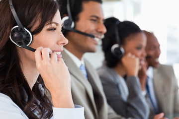 Young businesswoman working with a headset and accompanied by he