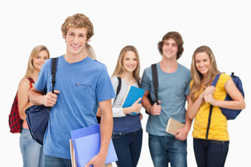 Obraz premium A group of smiling college students look into the camera as one
