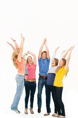 Fototapeta premium Group of friends cheering as they jump in the air and look at on