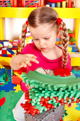 Child  playing with building block .