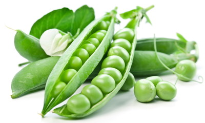 Pods of green peas with leaves