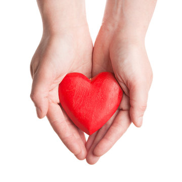 Red wooden heart in woman's hands