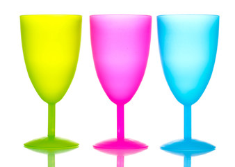 Bright plastic goblets isolated on white