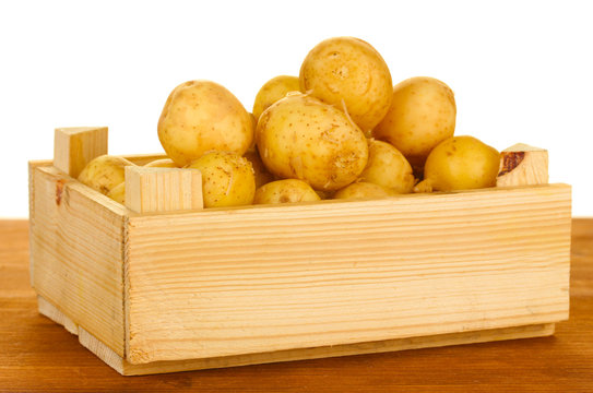 young potatoes in a wooden box