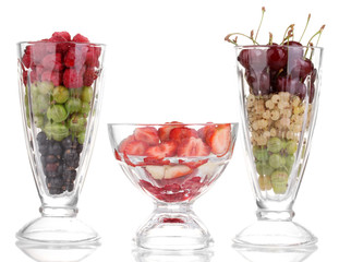 Mixed fruits and berries in glasses isolated on white
