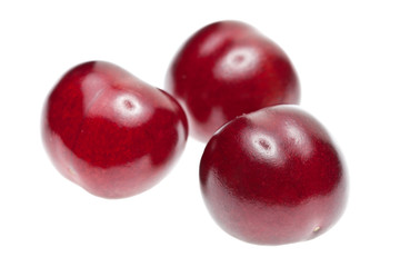 Three ripe cherries