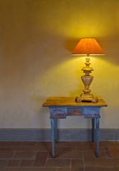 Antique interior with a lamp on a table