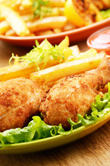 Fried drumsticks with french fries