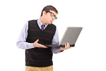 Young adult man giving a kiss and looking at a laptop computer