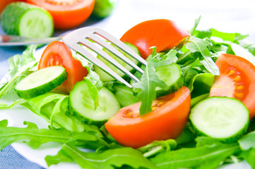 Fresh salad with tomatoes, rucola and cucumbers