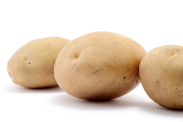Three potatoes isolated over white