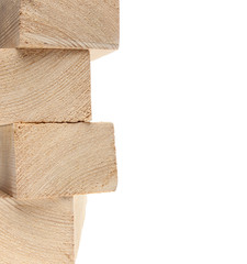 Stack of wooden 2X4s on white background with copy space.