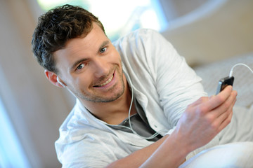Young man listening to music on smartphone