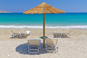 Deckchairs under parasol at Aegean Sea of Greece