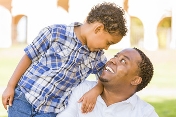Happy Mixed Race Father and Son Playing