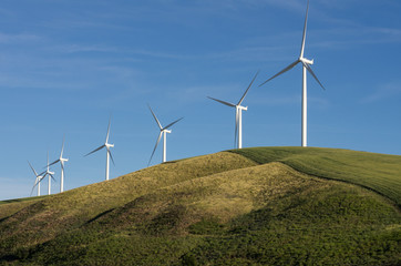 Row of wind turbines on hill