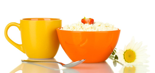 cottage cheese with strawberry in orange bowl and orange cup
