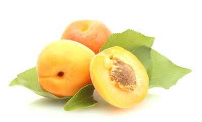 ripe sweet apricots with green leaves isolated on white