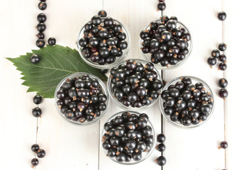 Fresh black currant in transparent bowls