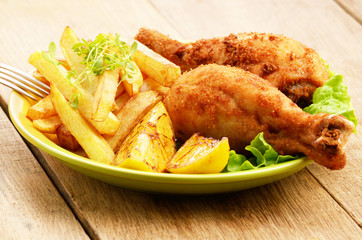 Fried drumsticks with french fries