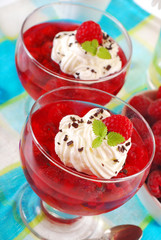 jelly dessert with raspberry and whipped cream