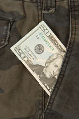 Macro shot of trendy jeans with american 20 dollar bill