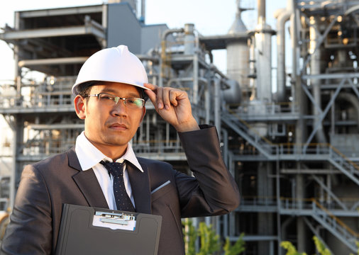 engineer oil refinery holding a notepad
