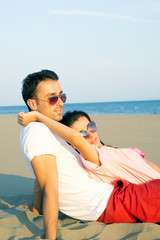 Happy couple at the beach in a playful mood